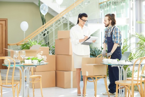 Female restaurant manager signing for delivery